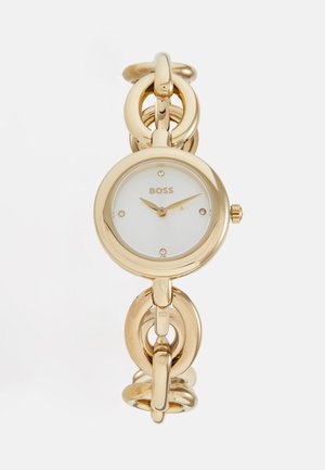 Montre en or avec un boîtier rond, un cadran blanc et un bracelet en chaîne. Éléments en cristal et logo « BOSS ». Fini lisse et brillant.