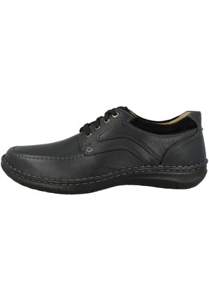Black leather shoe with a low profile, rounded toe, and lace-up design. Features contrasting stitching and a textured finish on the upper.