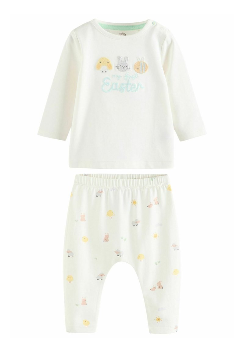 Ensemble pour bébé sur le thème de Pâques, comprenant une chemise à manches longues crème clair ornée d'animaux brodés et un pantalon assorti décoré de motifs pastel.