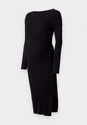 Abito premaman nero a coste con maniche lunghe, scollatura rotonda e spacco laterale. Presenta una silhouette aderente che si adatta a un pancione in crescita.