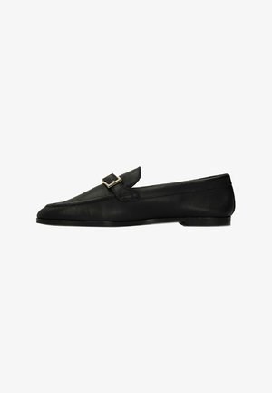 Black leather loafer with a gold buckle on top, flat heel, and rounded toe, shown in side profile on a white background.