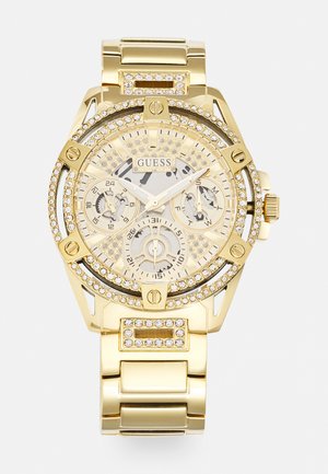 Gold-tone watch with crystal accents, textured dial, and a stainless steel band. Features chronograph subdials and a rotating bezel.
