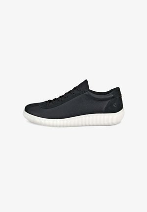 Black sneaker with a textured leather upper, rounded toe, and flat white rubber sole featuring a ribbed design. Laces and minimal branding.