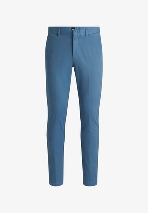 Pantalon en coton bleu avec une coupe slim, doté d'une fermeture éclair frontale, de passants de ceinture et d'un design épuré et minimaliste. Texture lisse sans motifs.