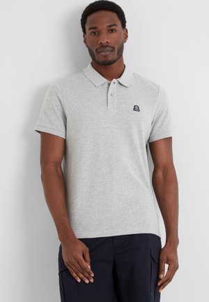 Gray polo shirt with a collar, two buttons, small navy logo on the chest, short sleeves, and a soft, textured cotton fabric.