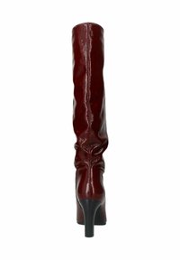 Knee-high, burgundy faux leather boot with a shiny finish, pointed toe, and slim black stiletto heel. Features gathered detailing.