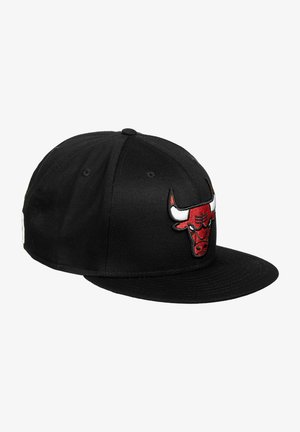Gorra de béisbol negra con visera plana, que presenta un logotipo de toro bordado en rojo y blanco en la parte frontal. Fabricada con tela de acabado texturizado.