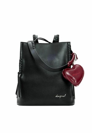 Bolso de cuero negro con detalles de correas torcidas y un bolso pequeño en forma de corazón rojo adjunto, con un pequeño logo blanco en la parte inferior derecha.