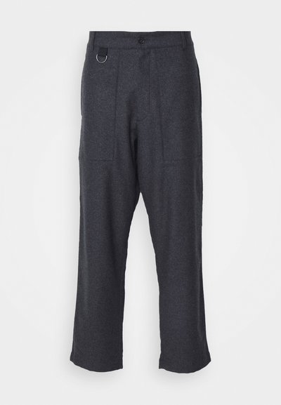 Gray wool trousers with a relaxed fit, featuring two front pockets, a button closure, and a metal ring accent on the waistband.