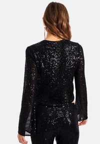 THE-ARE Chaqueta de entretiempo - black