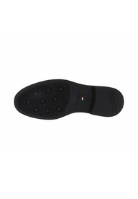 Semelle de chaussure noire avec des motifs de rainures circulaires à l'avant, talon lisse et petit détail du drapeau italien près de l'arche.