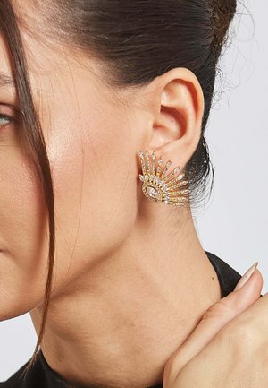 Gold-toned statement earrings featuring a sunburst design with clear rhinestones, showcasing a marquise shape and intricate detailing.