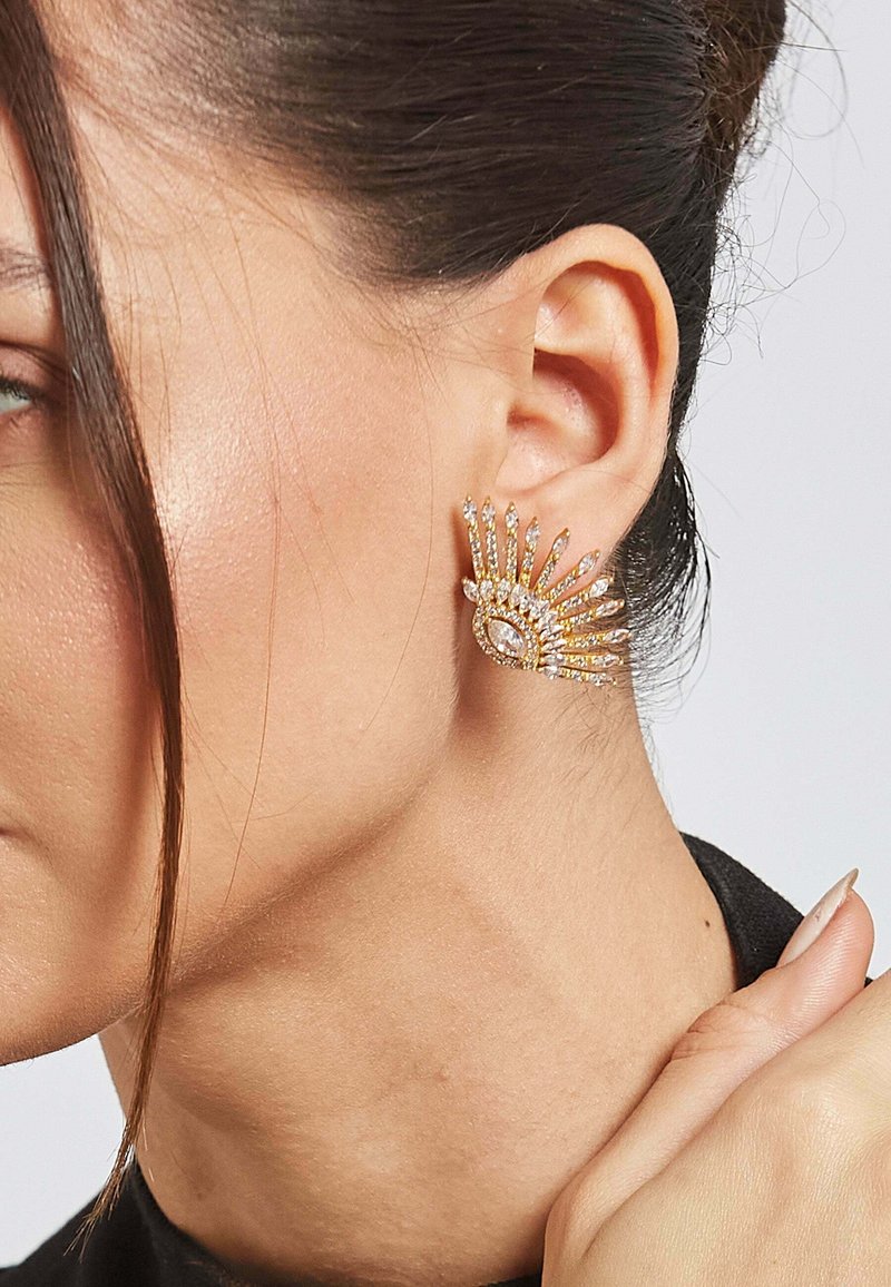 Zlato-tonirane izjave uhani z oblikovanjem sončnega žarka, okrašeni s prozornimi rhinestones, ki prikazujejo obliko marquise in zapleteno podrobnost.