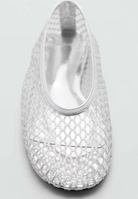 Zilveren mesh balletflat met een ronde neus en elastische rand. Honingraatpatroon zorgt voor textuur en ademend vermogen. Glad interieur.