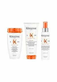 Kérastase Nutritive hair care set includes a white shampoo bottle with orange lid, a white tube, and a clear spray bottle with orange accents.