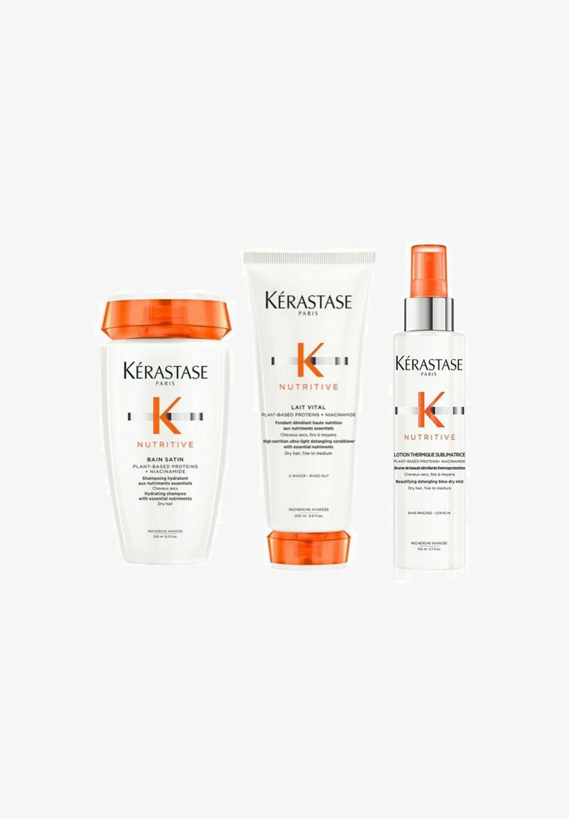 Kérastase Nutritive hair care set includes a white shampoo bottle with orange lid, a white tube, and a clear spray bottle with orange accents.