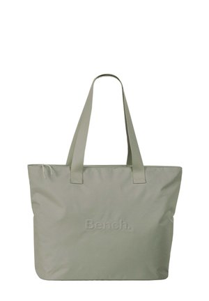 Sac fourre-tout vert clair en tissu doux. Dispose de deux poignées robustes et du logo en relief "Bench." sur le devant. Design simple et rectangulaire.