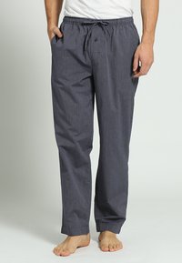 Gestreepte katoenen pyjamabroek in donkerblauw met een elastische tailleband, trekkoord en zijzakken. Lichtgewicht en ontspannen pasvorm.