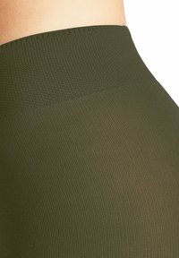 Leggings verde a vita alta con un motivo testurizzato a costine e un tessuto liscio, dotati di una cintura ampia ed elastica per il massimo comfort.
