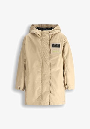 Beżowa kurtka wierzchnia z kapturem, z przodem z naszywką z tekstem, z zapięciem na zamek oraz teksturowanym materiałem. Długie rękawy i luźny krój.