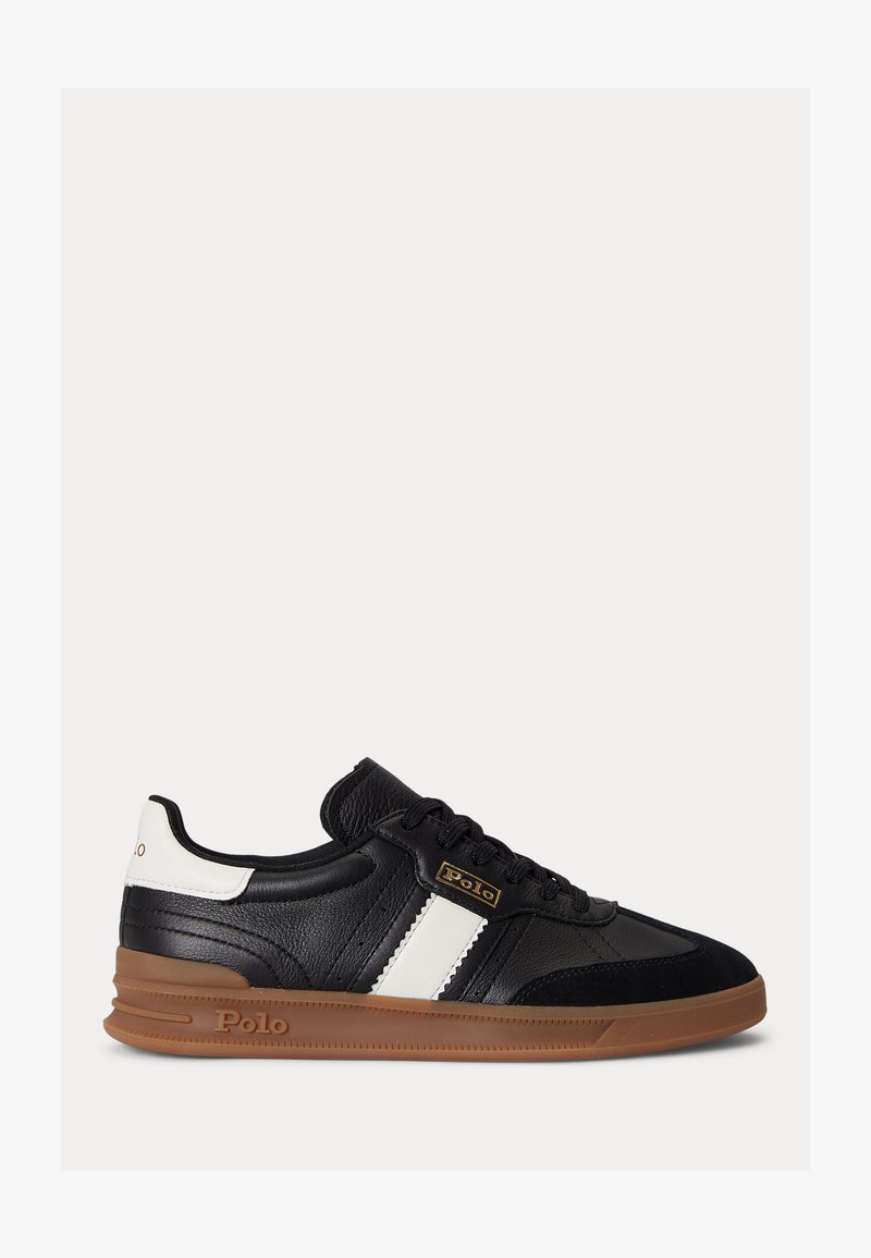 Black leather sneaker with white side stripe and heel detail, brown rubber sole, and "Polo" logo near laces and sole.