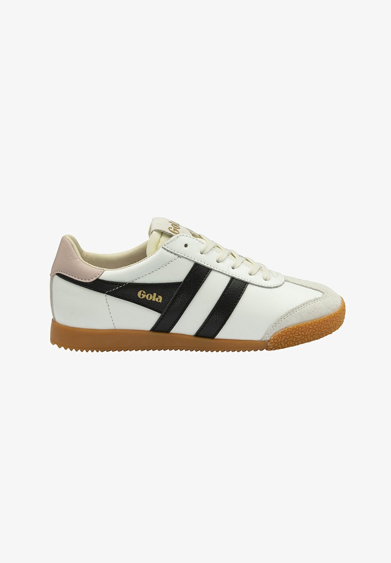 White sneaker with black stripes, gum sole, and light pink accents. Textured toe cap and gold logo detail on the side. Classic sports design.