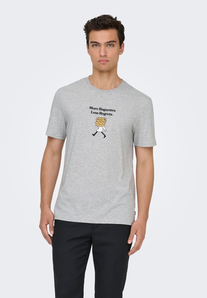 Γκρι βαμβακερό μπλουζάκι με μαύρο κείμενο, «Περισσότερες Μπαγκέτες, Λιγότερες Μετανοιώσεις», και μια καρτουνίστικη εικόνα μιας φιγούρας με στοιβαγμένα γλυκίσματα.