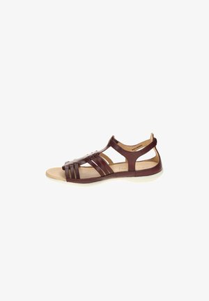 Brown leather open-toe sandal with multiple straps and cushioned beige insole, flat white sole, and back ankle support.