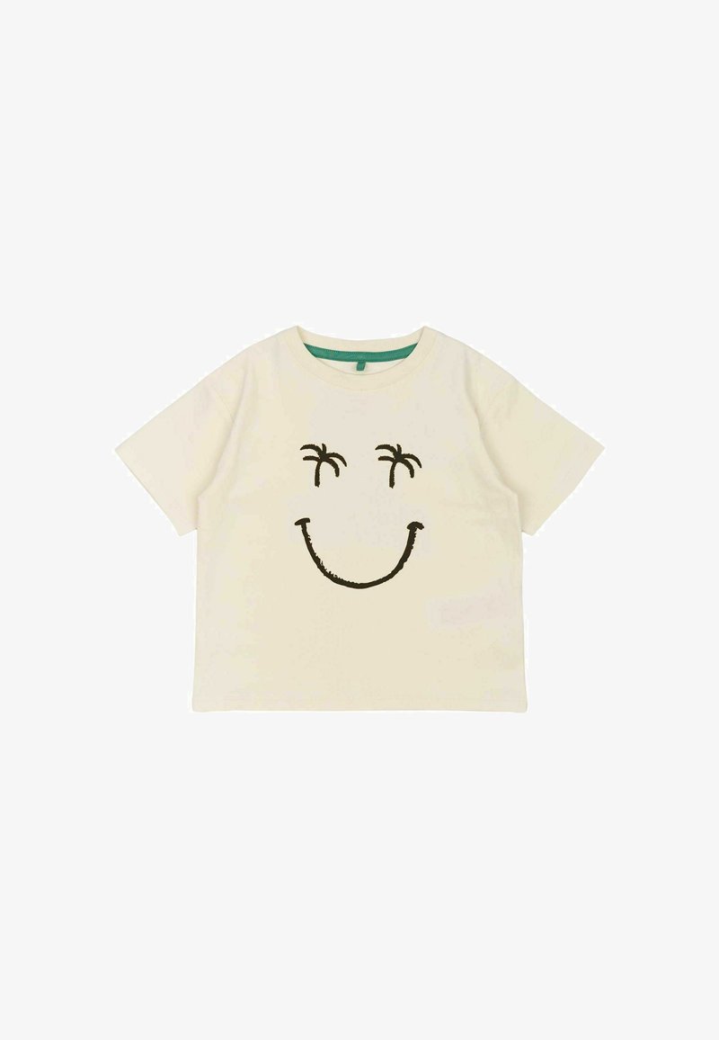 Kremo spalvos medvilninė marškinė su trumpomis rankovėmis, puikuojanti didele juoda šypseną vaizdu ir dviem palmėmis virš akių.