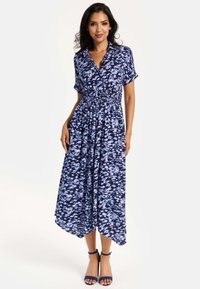 Navy blue dress with a floral pattern in varying shades of blue, short sleeves, cinched waist, and a flowing skirt with an asymmetrical hem.