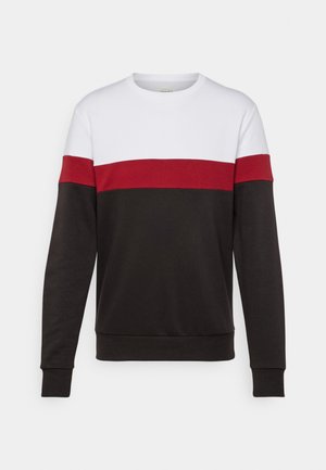 Värviline plokksweater, millel on valge ülemine osa, punane keskosa ja must alumine segment. Valmistatud pehmest ja mugavast kangast.