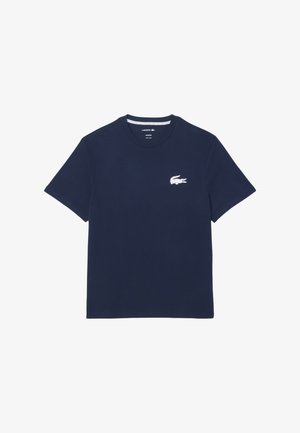 Marineblauwe katoenen t-shirt met korte mouwen, ronde hals en een witte geborduurde krokodillenlogo op de linkerborst. Reguliere pasvorm.
