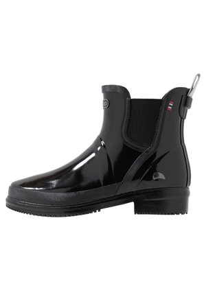 Botte de pluie noire brillante à la cheville avec panneaux latéraux élastiques, languette au talon et semelle texturée pour une bonne adhérence.