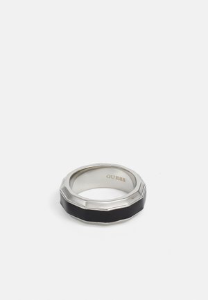Black and silver ring with an octagonal shape, featuring a polished silver band and a matte black inset. Marked with "GUESS" inside.
