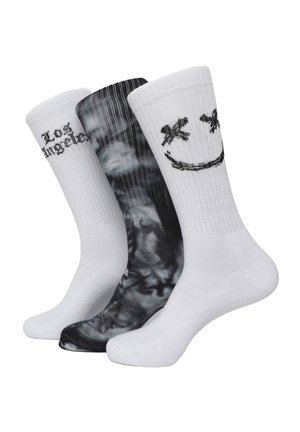 Tre paia di calze: un paio bianco con la scritta "Los Angeles", un paio bianco con una faccina sorridente e un paio nero con un motivo a vortice. Materiale in cotone misto.