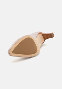 Light gray suede high heel shoe with a triangular toe, a wooden accent on the heel, and a beige rubber sole.