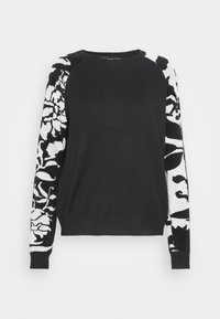 Pull noir à manches longues avec des motifs floraux contrastés blancs et noirs, des poignets côtelés et un col rond.