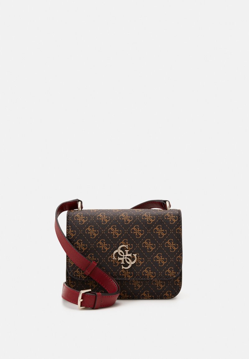 Brown patterned crossbody bag with gold monogram logo and adjustable burgundy leather strap on white background.