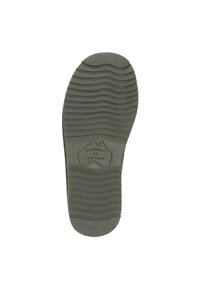 Donkergroene rubberen zool met horizontale en verticale groeven voor grip. Heeft een logo met "WARMBAT" en "AUSTRALIË."