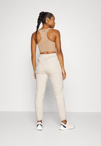 Casall JOGGER - Calças de fato de treino - light sand