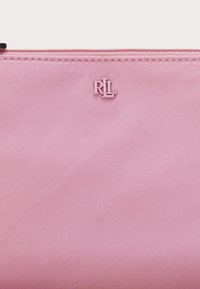 Pink nylon pouch with a smooth texture, featuring a subtle "RL" logo in a matching pink tone on the front and a zip closure.