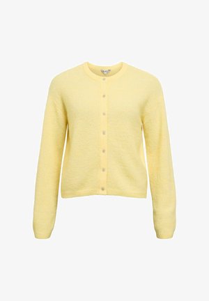 Keltainen neuletakki pehmeästä kankaasta, pyöreällä pääntiellä, pitkillä hihoilla ja neljällä napilla suljettava edusta.