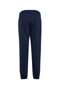 Mørkeblå joggingbukser med elastisk talje og ankelmanchetter, vist bagfra på hvid baggrund.