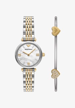 Silver and gold-tone watch with a mother-of-pearl face, indexed with clear crystals; includes a heart-accented bangle bracelet.