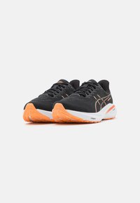 Black athletic shoes with orange accents; fabric upper, textile laces, cushioned heel, and textured rubber sole for traction.