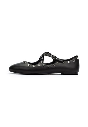 Bailarinas de cuero negro con punta redondeada, correa de hebilla y tachuelas decorativas plateadas a lo largo de los lados. Suela plana, diseño minimalista.