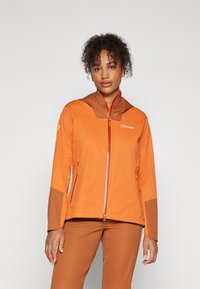 Orange outdoor jacket with a brown hood and lower sleeves. Features a front zipper, logo on the chest, and two side pockets. Smooth fabric.
