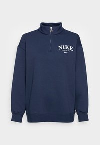 Marinblå zip-necks sweatshirt gjord av mjukt material. Har en logotyp på bröstet och ribbstickade muddar. Avslappnad passform med hög krage.