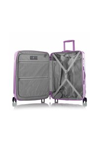 Hard-shell purple suitcase with a gray interior, featuring zippered pockets, cross straps, and a retractable handle. Four wheels.
