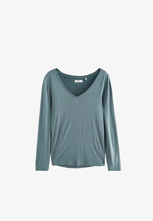 Ilgų rankovių marškinėliai iš minkštos, blankios teal spalvos medžiagos su V formos iškirpte. Sukurtas laisvam prigludimui, be matomų raštų ar metalinių akcentų.